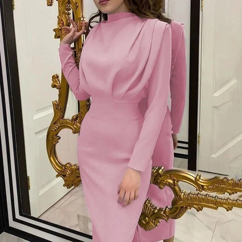Pink high-neck maxi dress with dramatic sleeves, made of soft and flowy fabric. Perfect for a chic and sophisticated look.