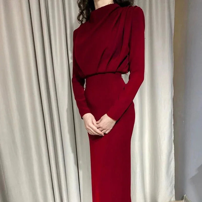 "Wine red high-neck maxi dress with dramatic sleeves, crafted from flowy, elegant fabric. Perfect for special occasions."