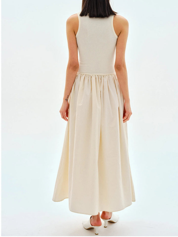 "Tania sleeveless jersey dress in black, gathered waist, knee-length design, perfect for casual wear or office attire."