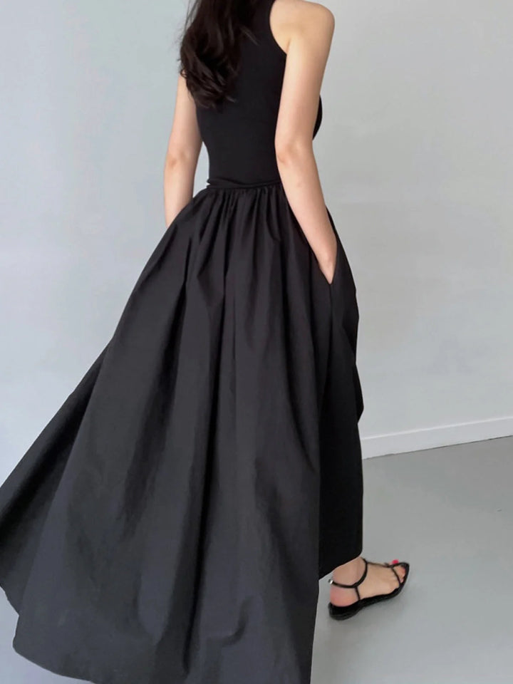 "Sleeveless jersey dress featuring a gathered waist design by Tania, perfect for casual or formal occasions."