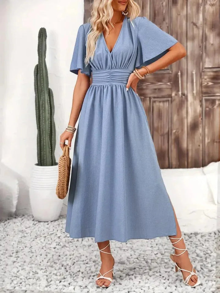 Light blue V-neck sundress with ruffled sleeves by Rosalinde, perfect for a casual summer day. Made of breathable and soft…