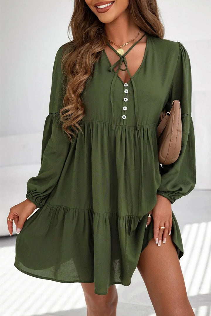 "Gabriella mini dress with tiered design and lace-up front detail in soft and airy fabric."