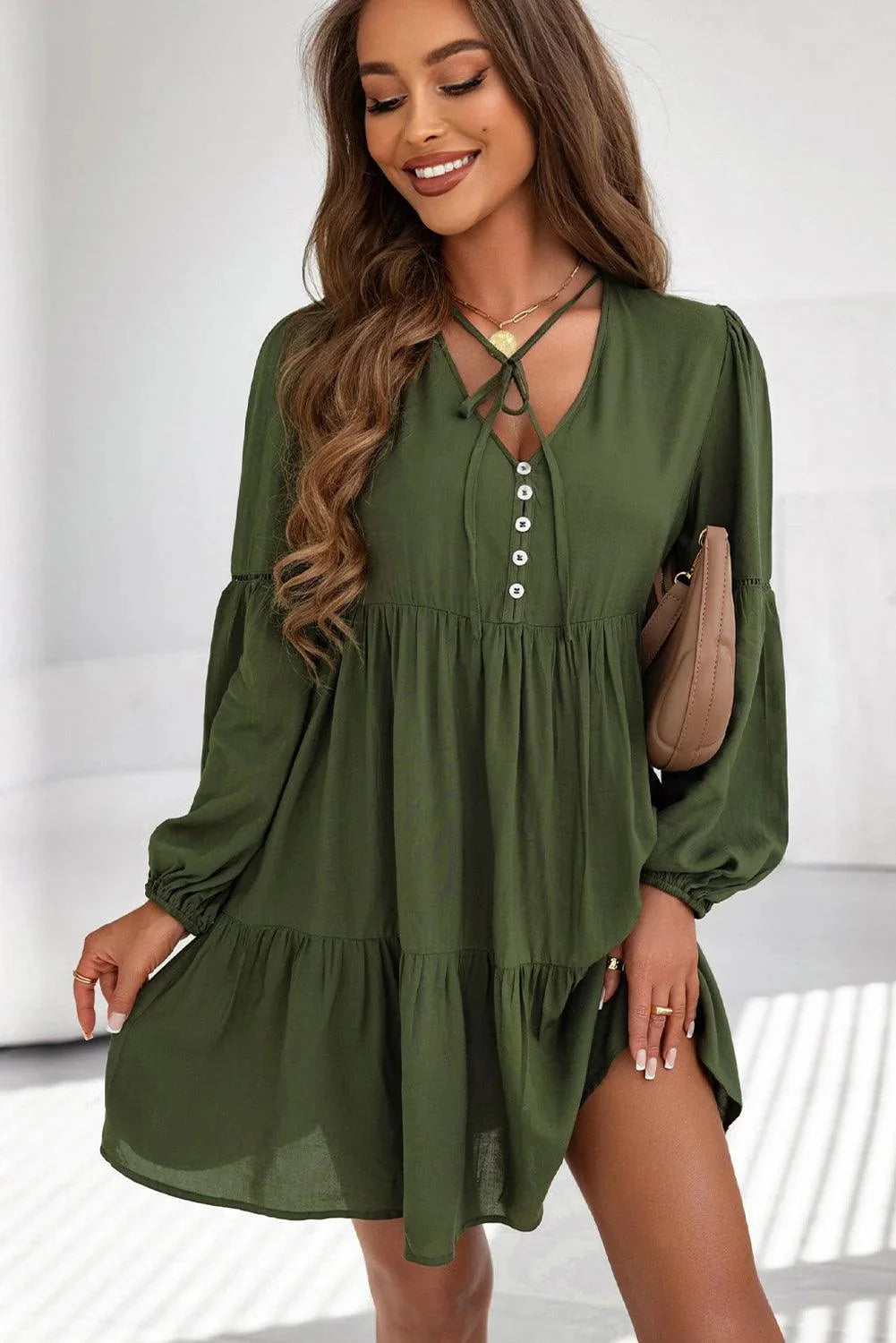 "Gabriella tiered mini dress with lace-up front in textured fabric, perfect for a casual yet stylish look."