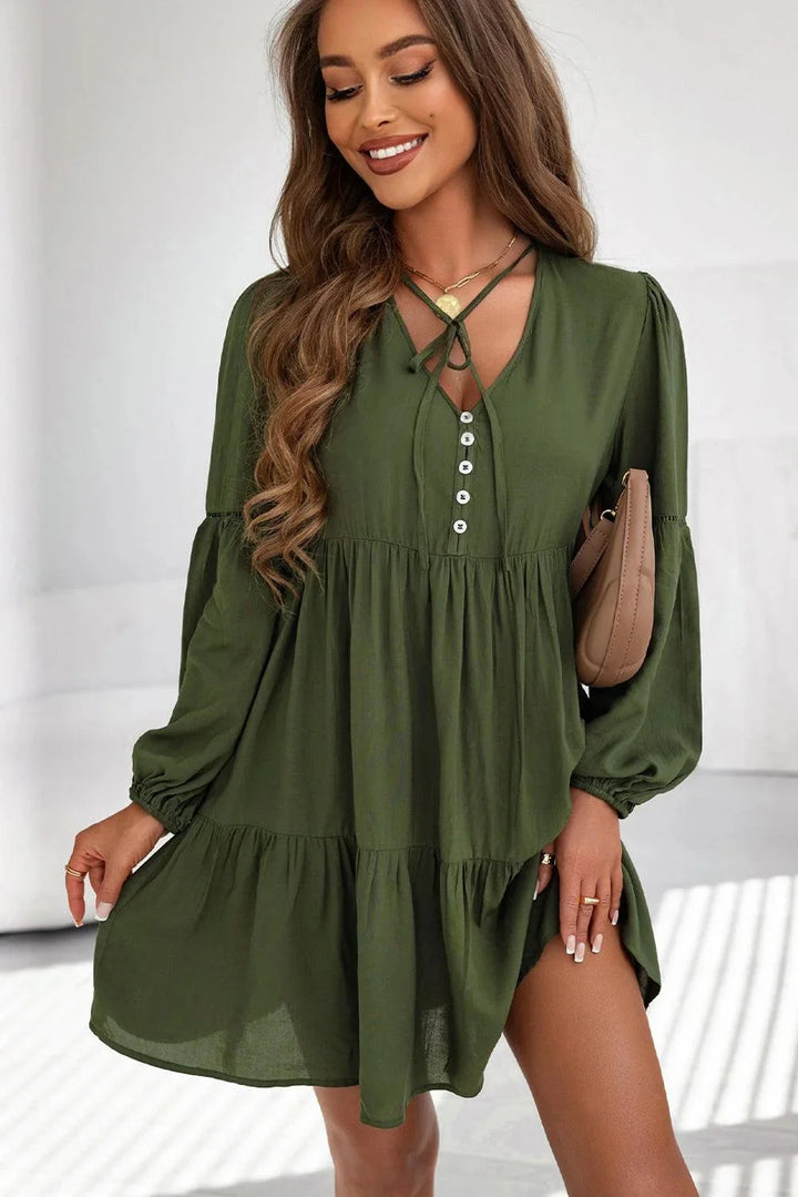 "Gabriella tiered mini dress with lace-up front in textured fabric, perfect for a casual yet stylish look."
