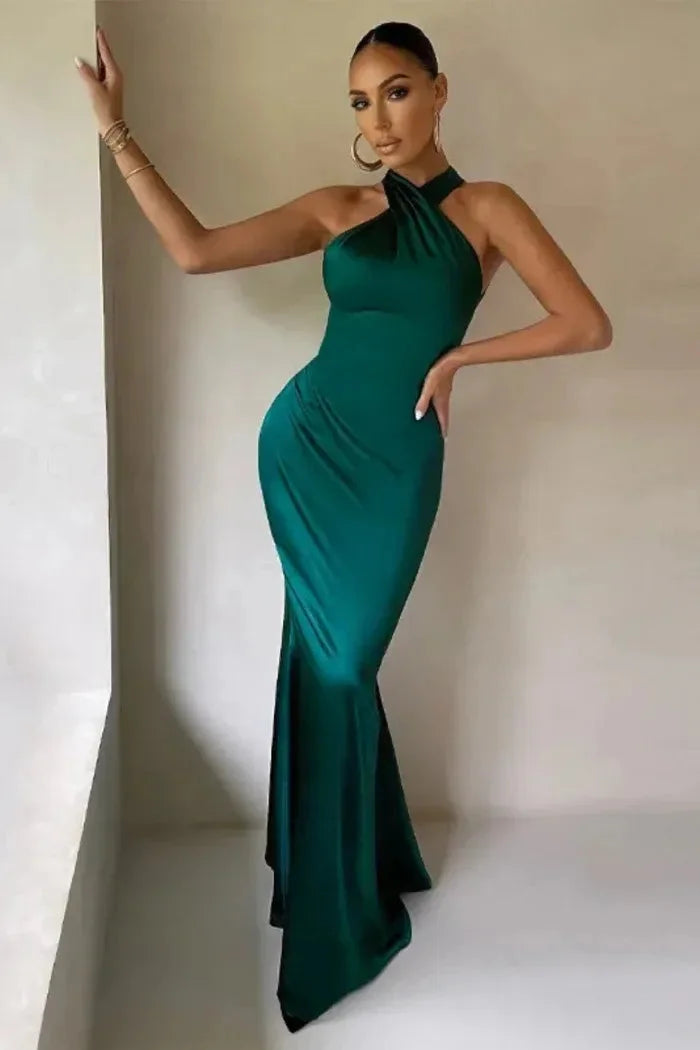 Green Denisse maxi dress with a sleek silhouette, perfect for special occasions. Made of a figure-flattering fabric with a…