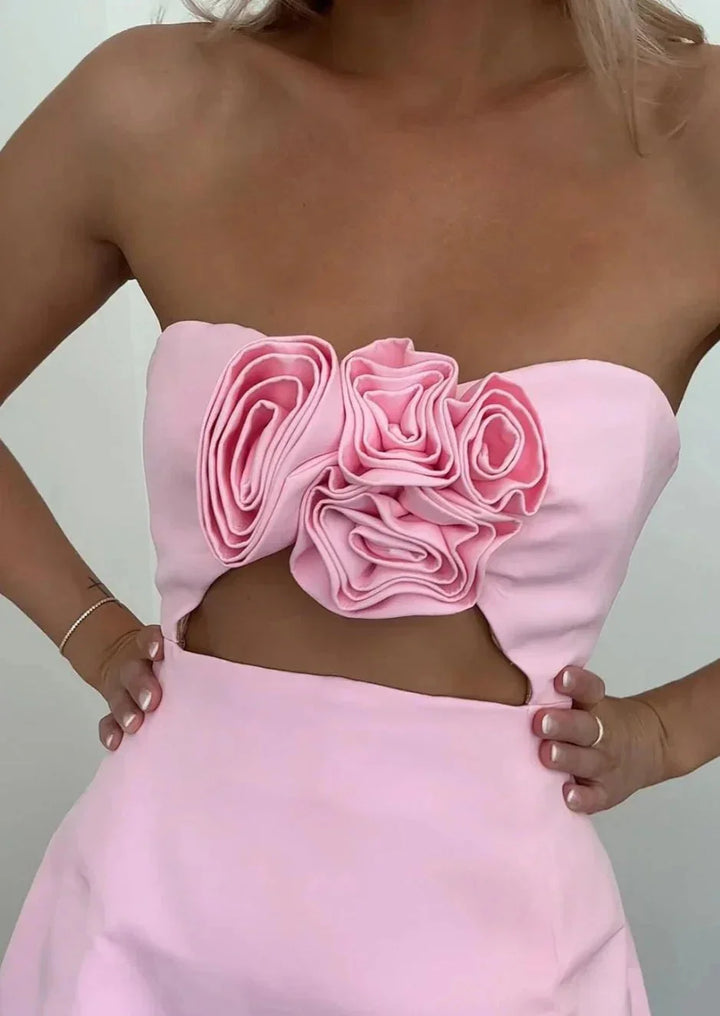 Strapless mini dress in Kaileen material with floral accent detailing.