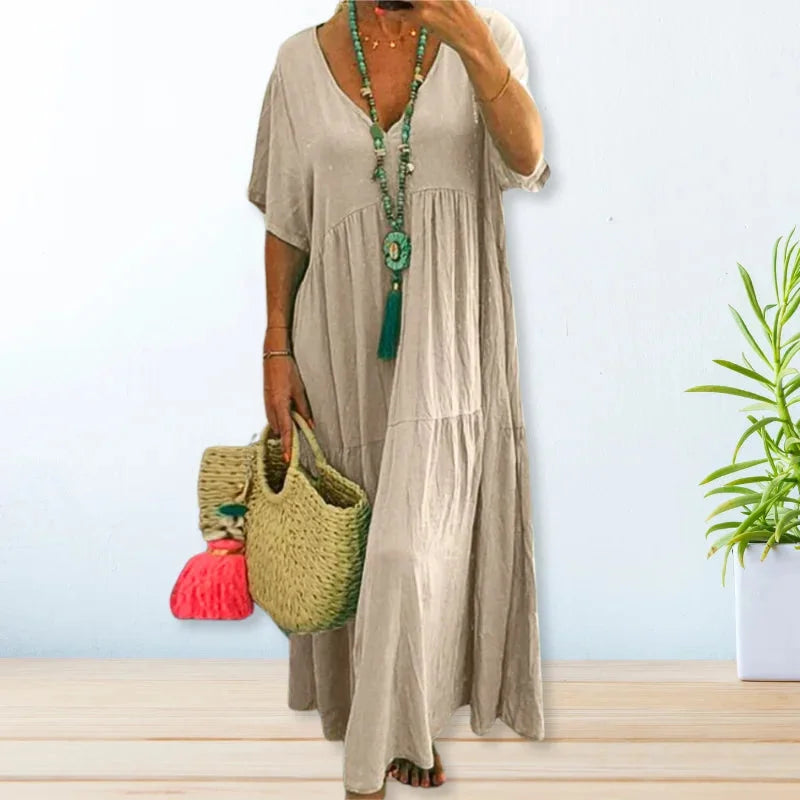 "Constance maxi dress in lightweight fabric with a flattering V-neck design, perfect for summer outings."