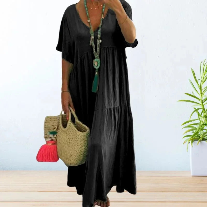 Black V-neck maxi dress by Constance, perfect for summer. Made with lightweight fabric, featuring a flattering design with a…