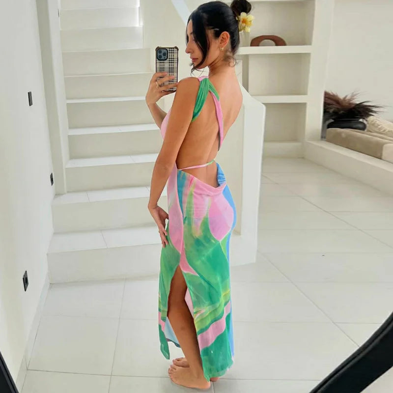 "Sleeveless maxi dress with vibrant tropical print, perfect for summer days. Soft and lightweight fabric for effortless…