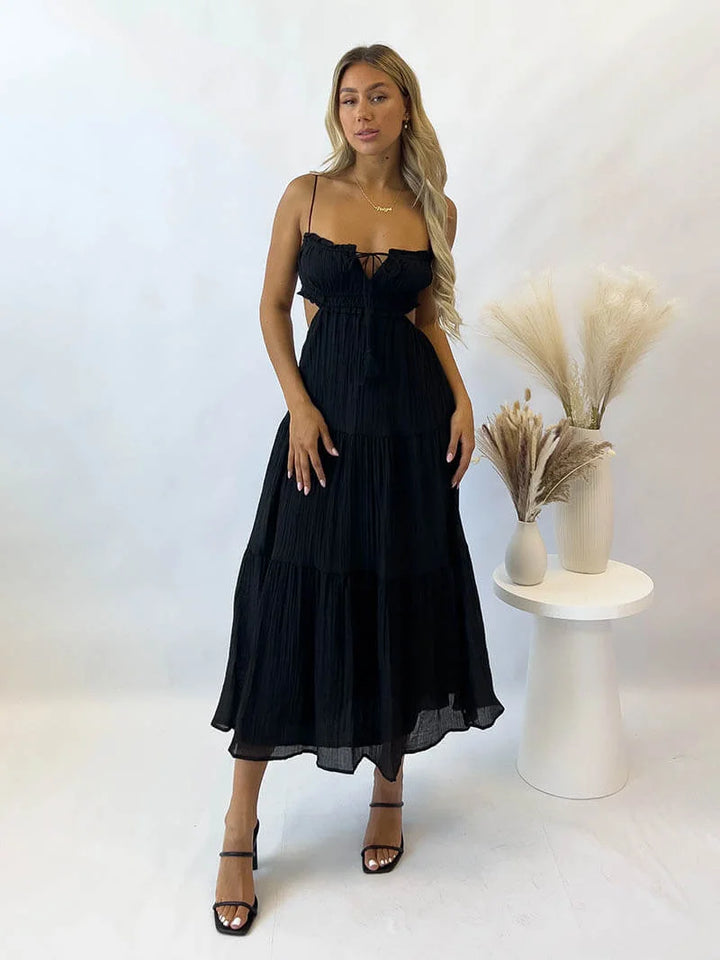 Black tiered maxi dress with drawstring, ideal for casual outings. Made from soft, flowy fabric with a relaxed fit for…