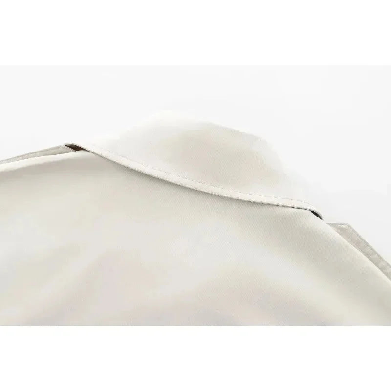 Ivory structured jacket with double-breasted design, tailored fit, and high-quality fabric by Carmela.