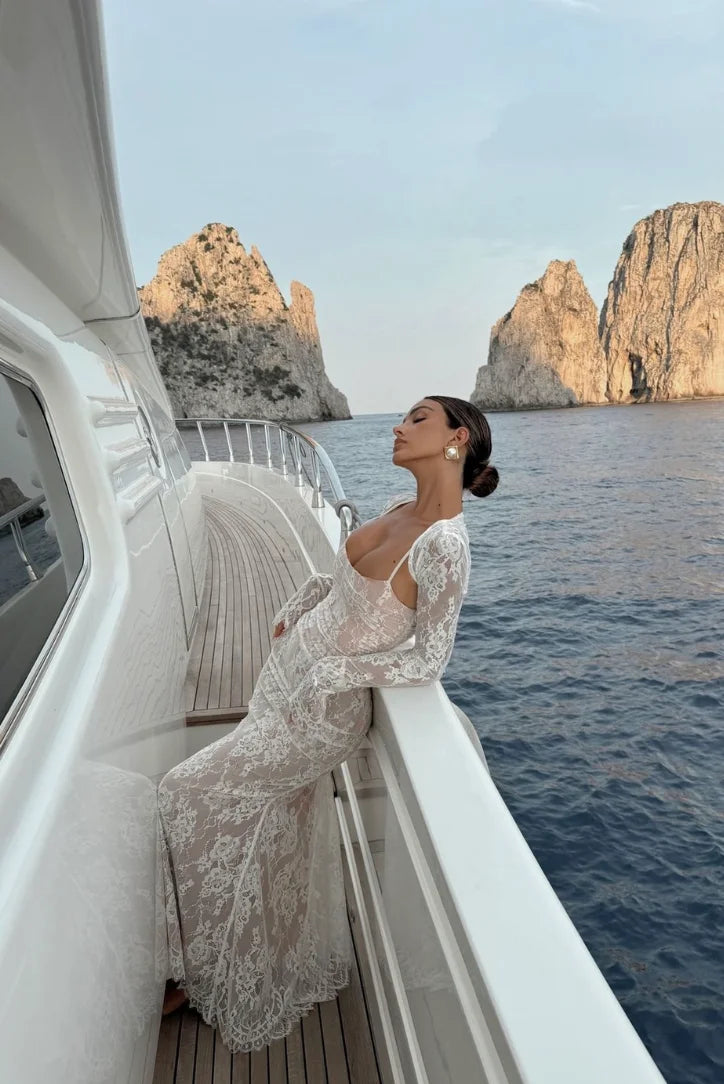 White lace dress with sleeves, elegant and feminine design. Perfect for special occasions or casual outings.