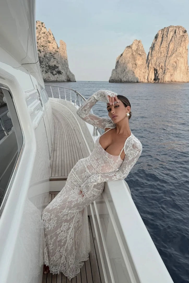 "White lace long dress with sleeves, elegant and chic design, perfect for special occasions."