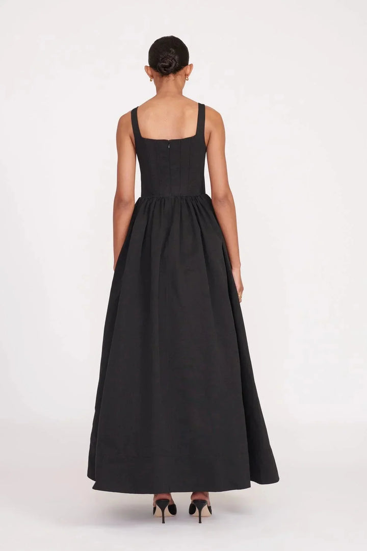 Black square neckline midi dress in a sleeveless style by Aleah. Versatile and elegant with a stylish design and timeless…