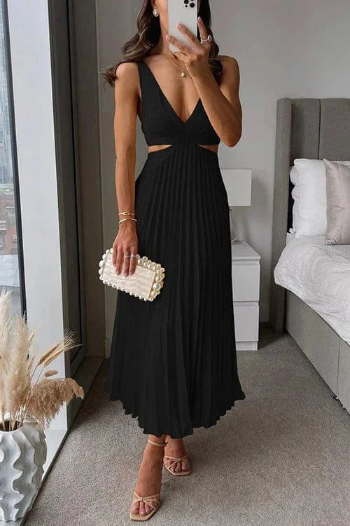 Black pleated midi dress with cut-out accents by Quetzalli. Made of soft and flowy fabric, perfect for a sophisticated look.