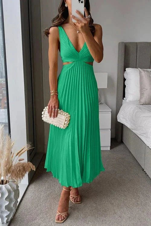 Green pleated midi dress with cut-out accents by Quetzalli, perfect aesthetic for summer events or casual gatherings.