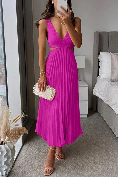 Pink pleated midi dress with cut-out accents from Quetzalli. Feminine and elegant design perfect for special occasions.