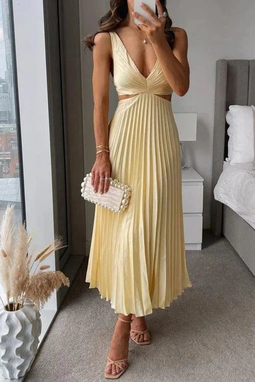 Yellow pleated midi dress with cut-out accents by Quetzalli. Features a soft and flowy fabric perfect for special occasions.