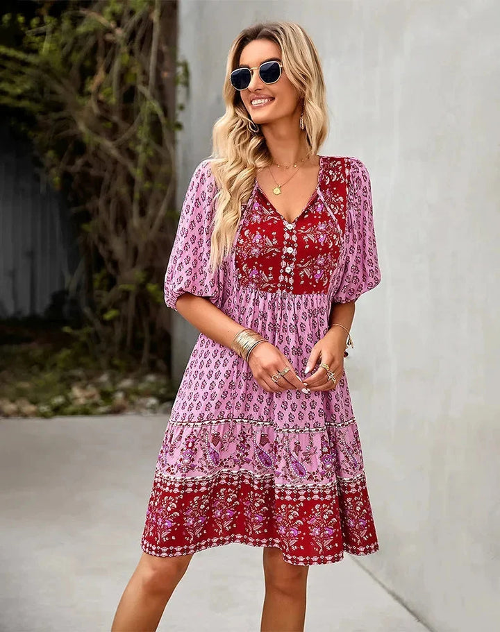 "Laniyah mini dress in black with elastic waist, V-neck design, and above-the-knee length, perfect for casual outings and…