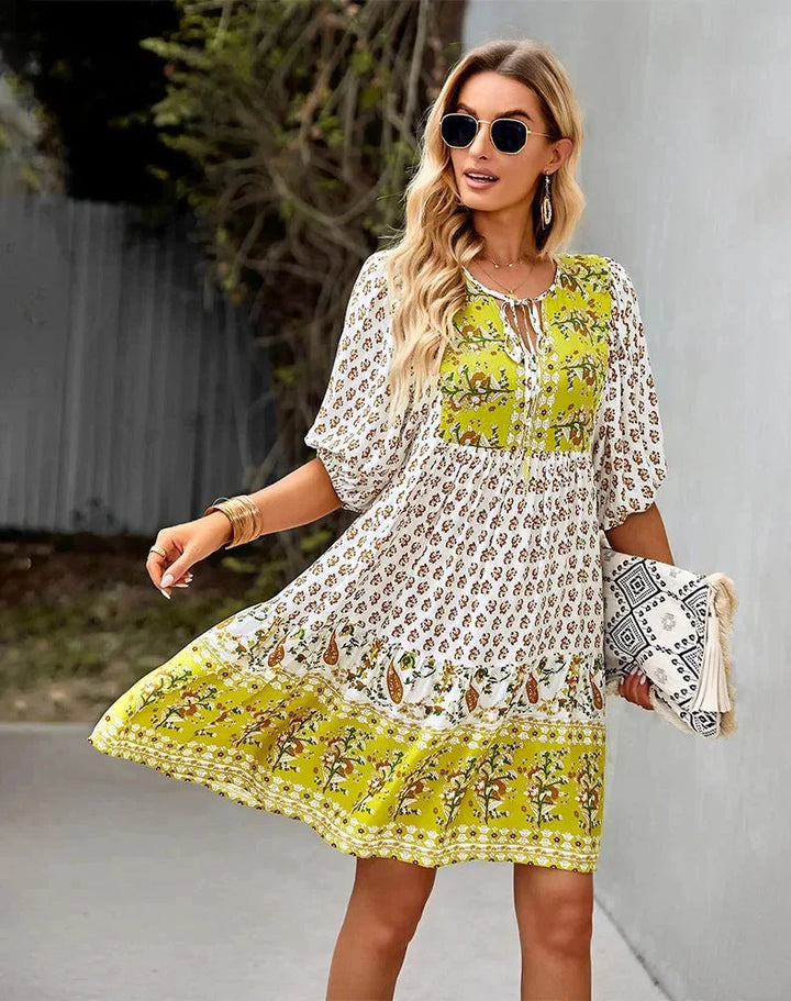 "Laniyah mini dress with elastic waist and V-neck in a soft and breathable fabric, perfect for casual occasions."