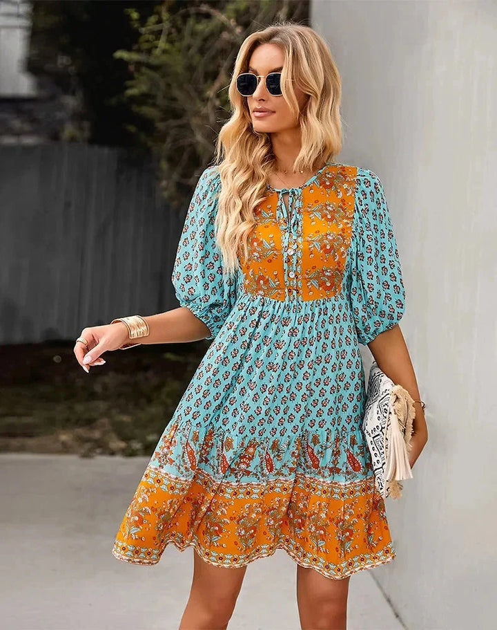 "Laniyah - Black v-neck mini dress with elastic waist, perfect for a casual outing. Made of soft and stretchy fabric."