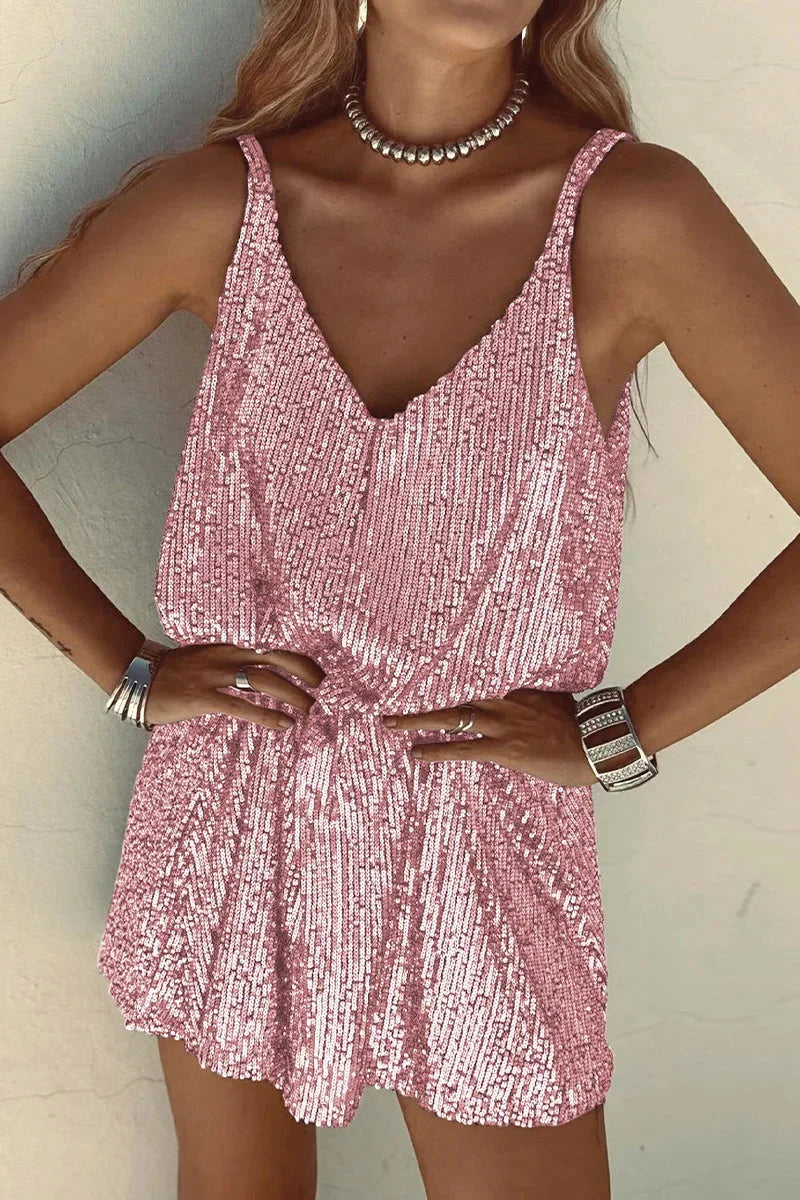 Pink sequin V-neck romper with a sleeveless silhouette. Glamorous and shimmering design perfect for a night out or special…
