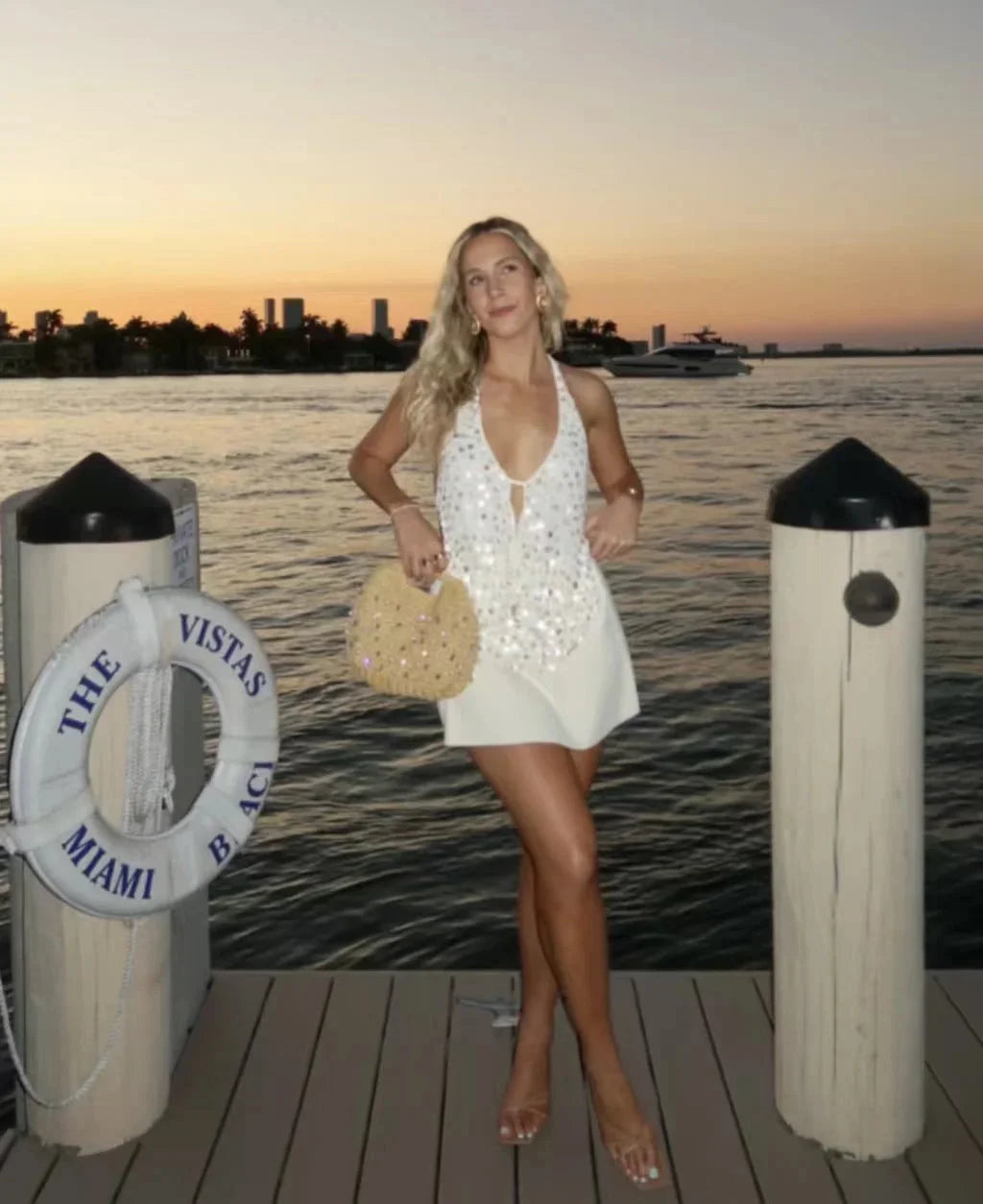 Ivory sequined halter neck tank top for women. Features sparkly sequins in a stylish halter neckline design.