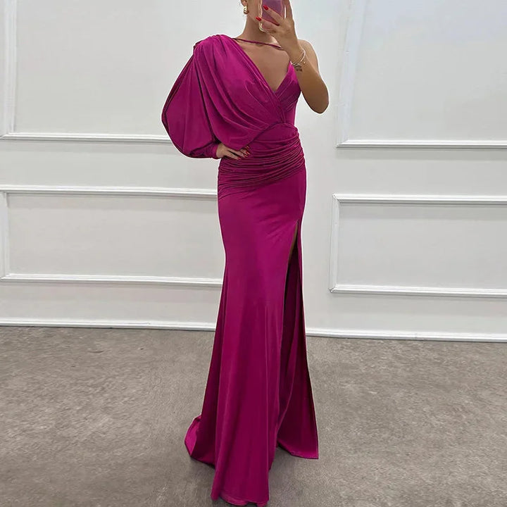 Pink Katarina dress with one-shoulder design and side slit. Made from soft, flowing material. Stylish and elegant for any…