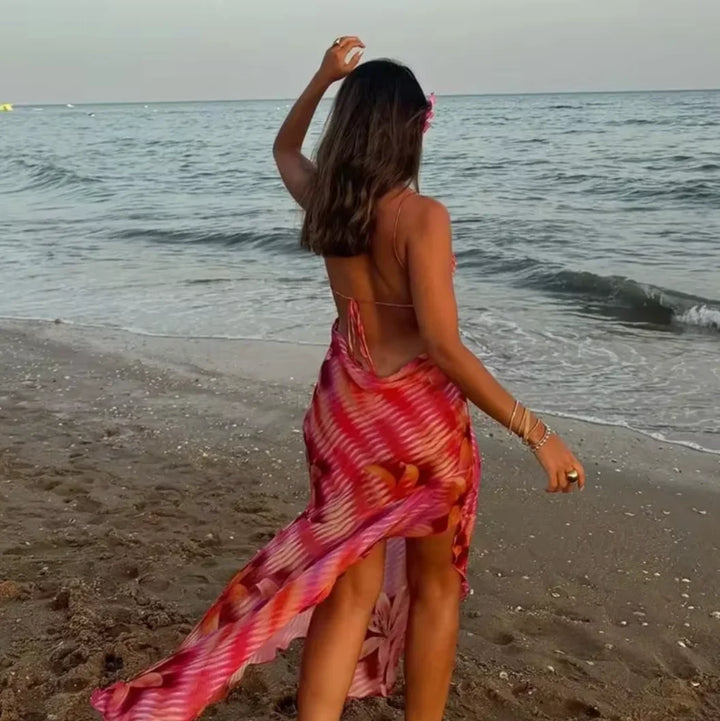 "Alana beach dress featuring a vibrant tropical print, designed to flow elegantly. Perfect for those sunny days by the…