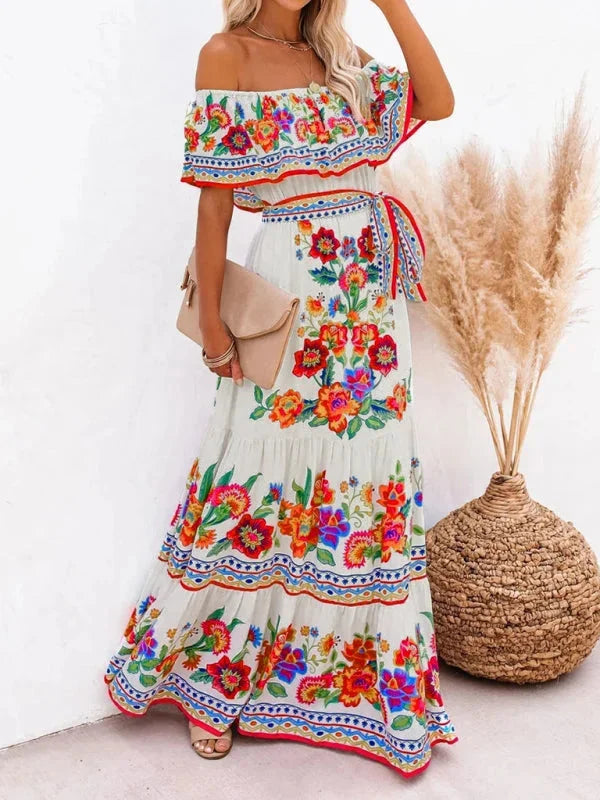 "Amyla maxi dress with floral print, tiered design, and belt detail in lightweight fabric, perfect for summer outings."