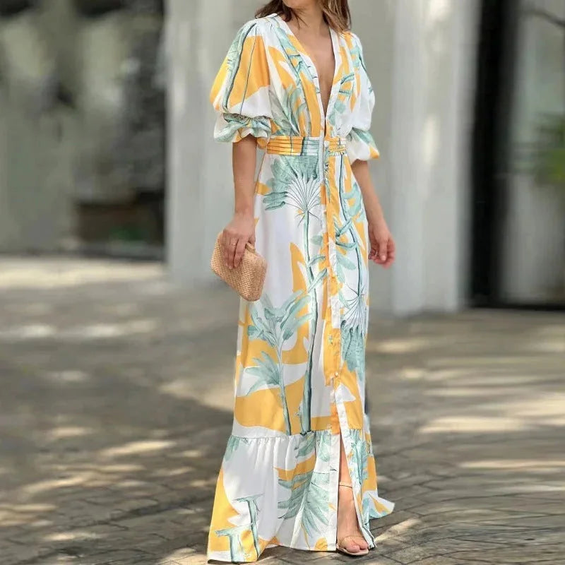 Yellow V-neck maxi dress by Nahia, with tropical print and sleeves. Made from lightweight fabric, perfect for summer days.