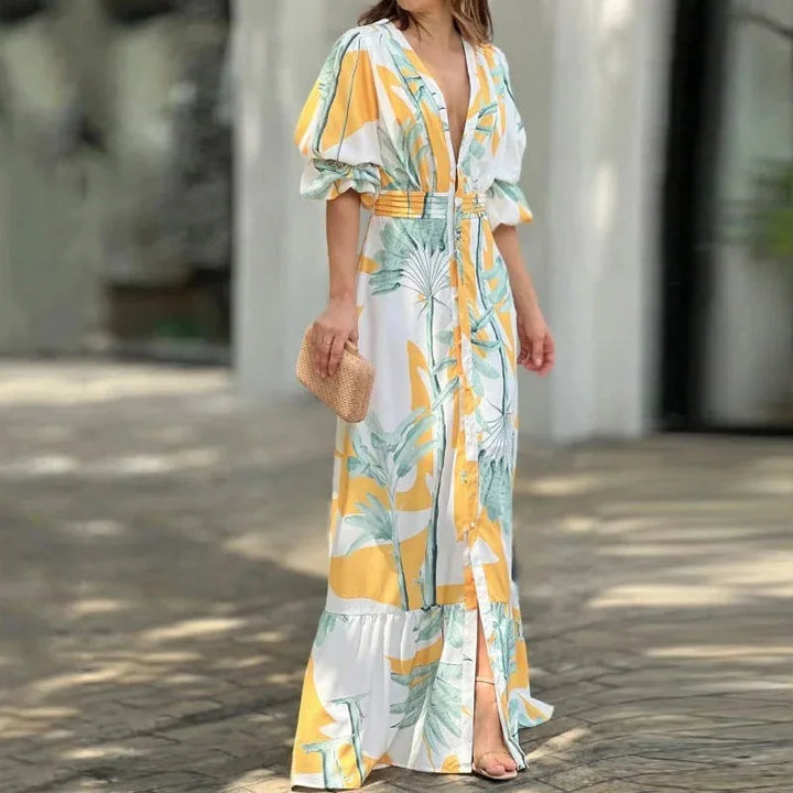 Yellow V-neck maxi dress by Nahia, with tropical print and sleeves. Made from lightweight fabric, perfect for summer days.