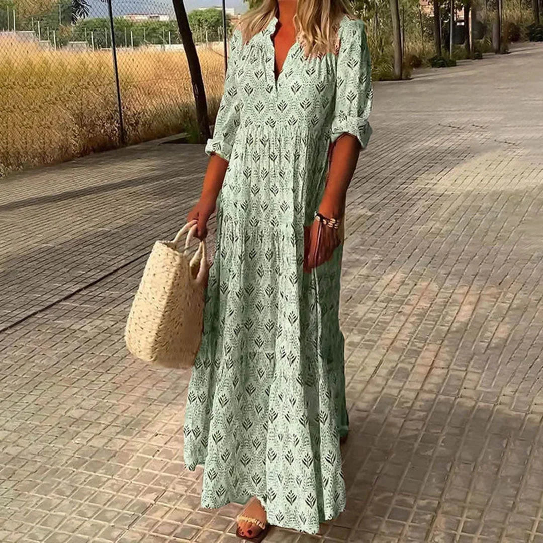 "Green V-neck maxi dress with sleeves, crafted in soft, flowy fabric. Perfect for casual or semi-formal occasions."
