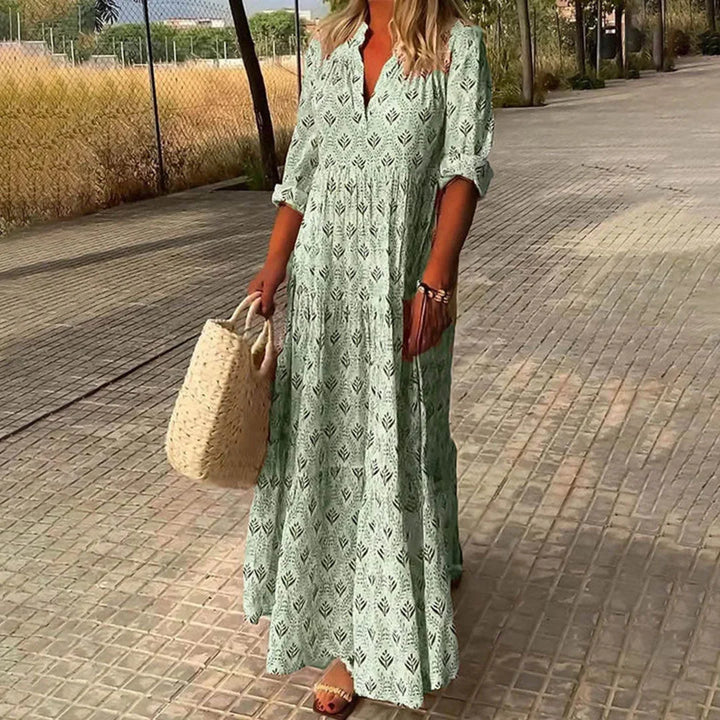 "Green V-neck maxi dress with sleeves, crafted in soft, flowy fabric. Perfect for casual or semi-formal occasions."