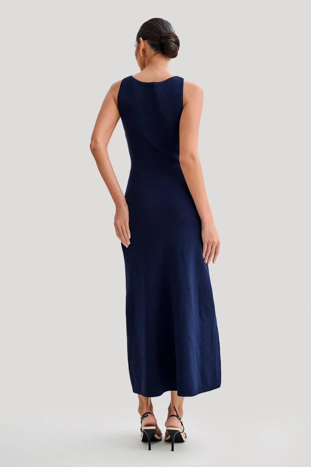 Sleeveless midi dress in blue with button front detailing, a flattering waist tie, and a flowy design by Junie.