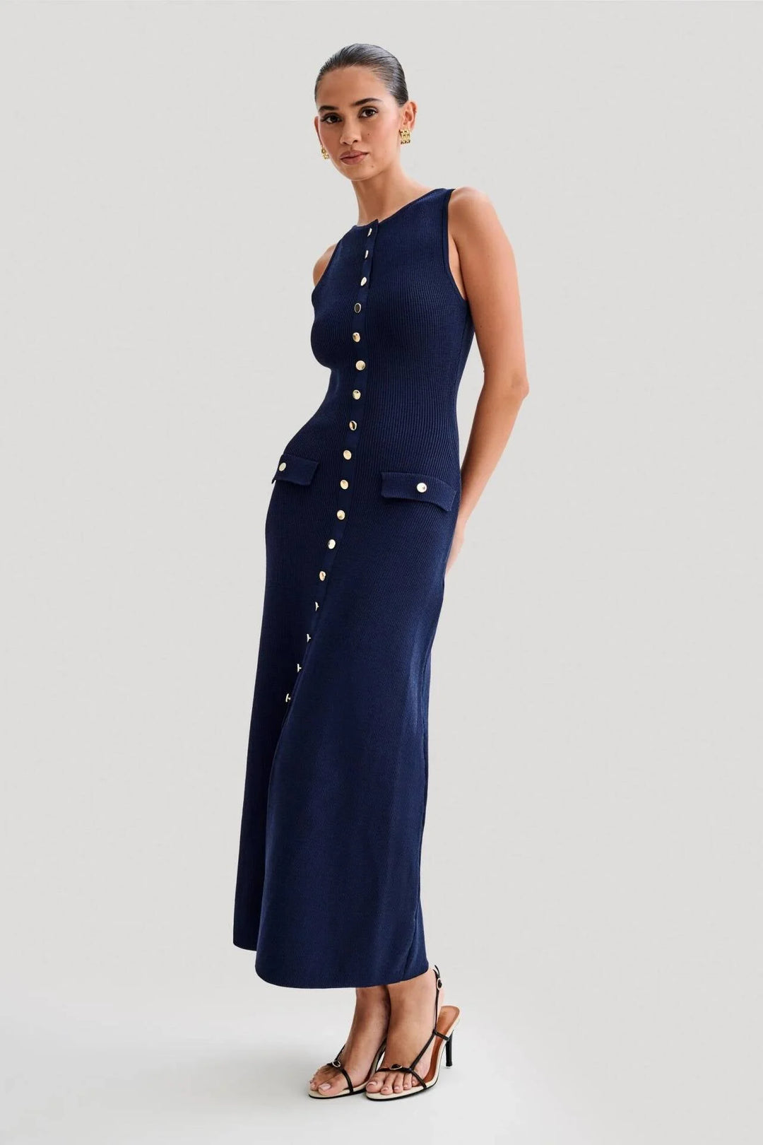 Blue sleeveless midi dress with button front by Junie. Made from lightweight cotton with a subtle textured pattern.