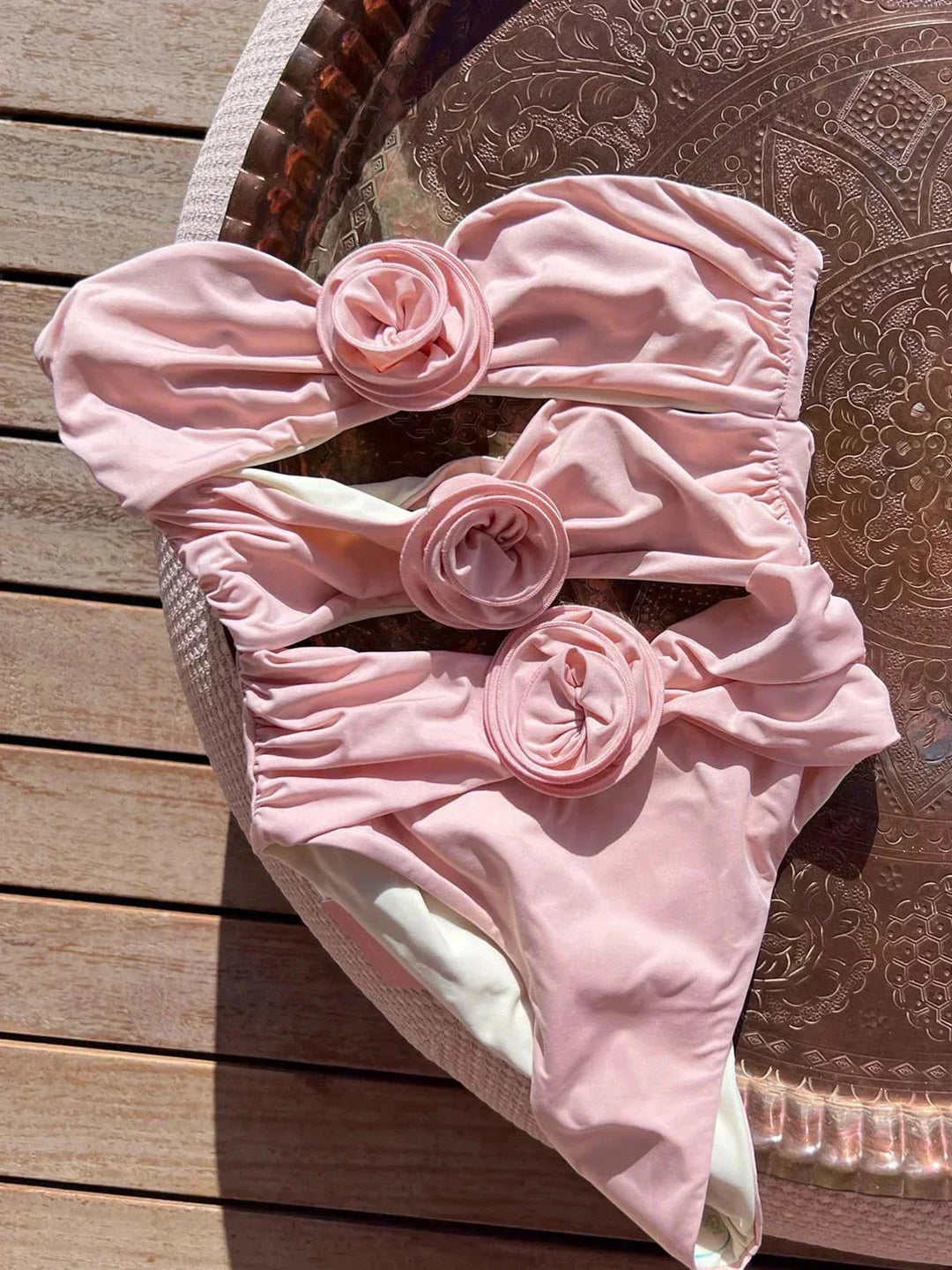 Pink form-fitting strapless swimsuit for women by Icelynn, featuring a sleek design and made from high-quality stretch…