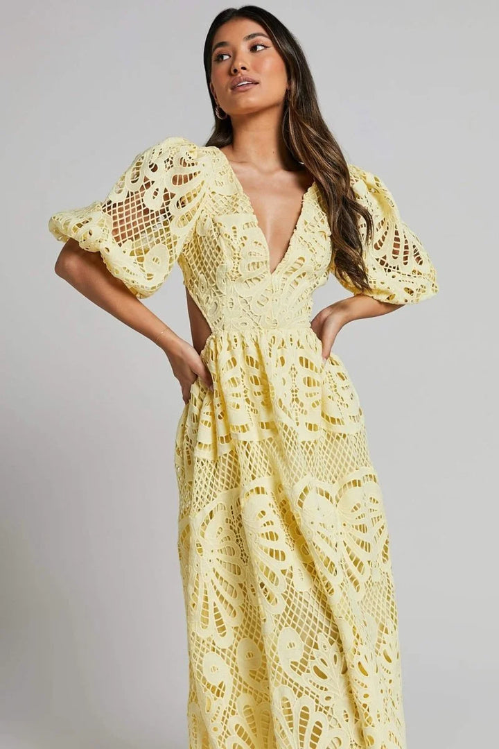 "Roslyn mid-length lace dress with V-neckline in white, featuring intricate floral lace pattern and flattering…