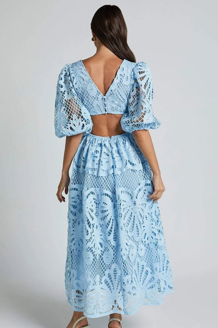 "Roslyn mid-length lace dress in navy with V-neckline and intricate floral pattern."