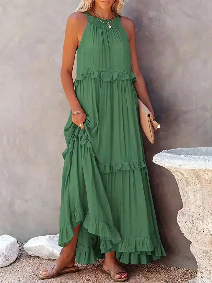 Green sleeveless tiered maxi dress by Wylie. Made of soft cotton blend with a flowy design, perfect for spring and summer…
