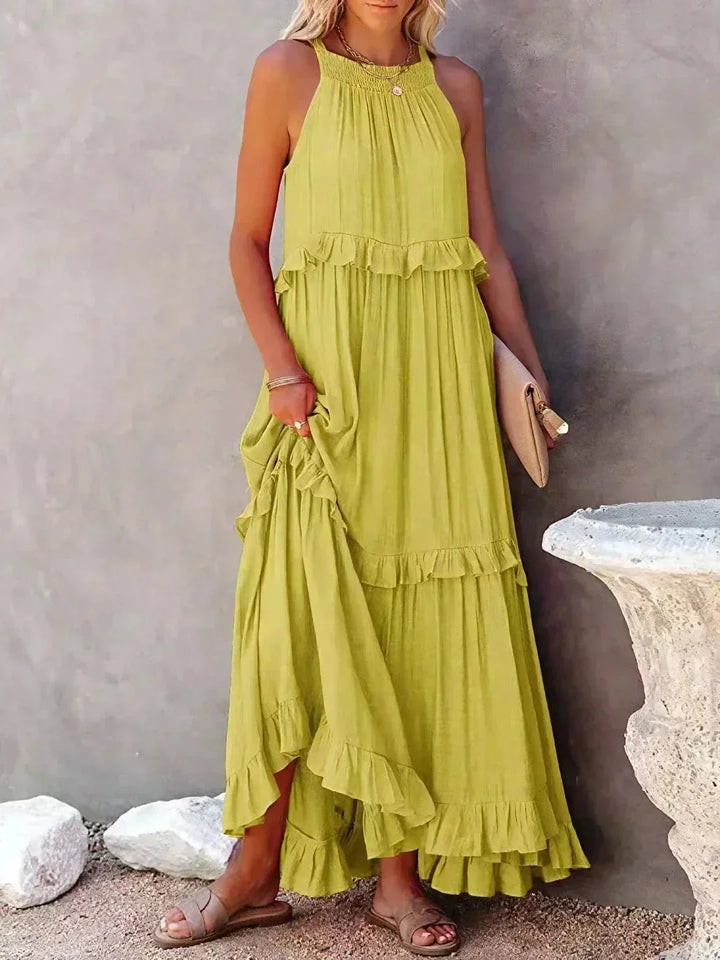 Yellow sleeveless tiered maxi dress by Wylie. Made of lightweight cotton blend, features ruffle tiers and a flowy…