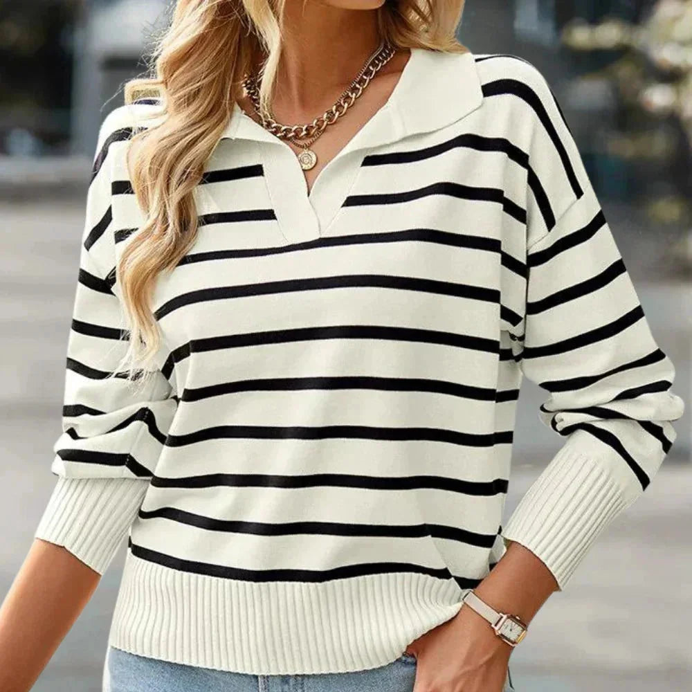 Black striped zip-up pullover with a collared design, perfect for casual wear. Made of cozy and comfortable material.