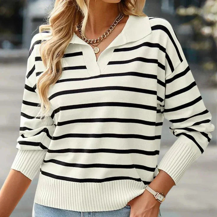 Black striped zip-up pullover with a collared design, perfect for casual wear. Made of cozy and comfortable material.