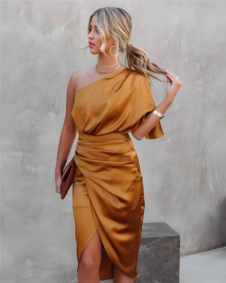 Orange draped midi dress made from soft jersey fabric with a stylish Janessa neckline, perfect for a chic and sophisticated…