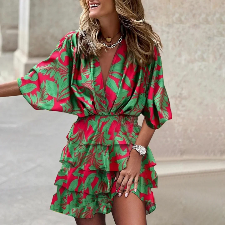 Green floral wrap mini dress with flared sleeves made from soft linen blend fabric, perfect for casual and stylish day looks.