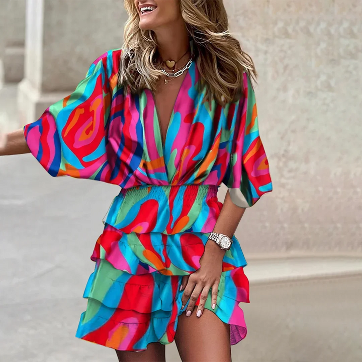 Pink flared sleeve wrap mini dress made of soft cotton blend with a stylish tie waist detail. Perfect for a casual chic look.