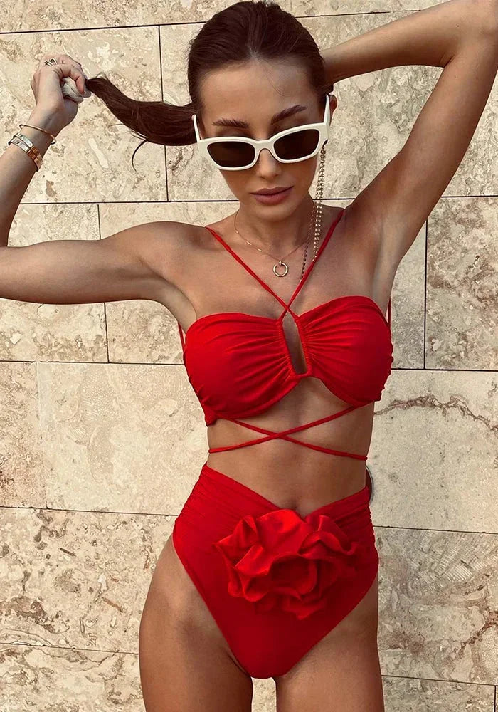 Women's bikini set featuring rose appliqué detail on top and bottom, made from high-quality fabric in a trendy design.