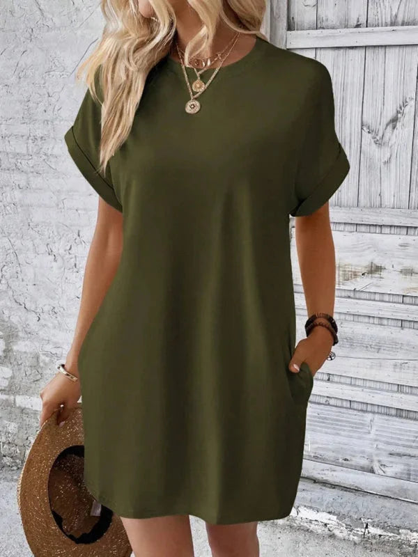 Green Taniyah mini dress with convenient pockets, made from soft cotton blend. Knee-length design with a relaxed fit for…