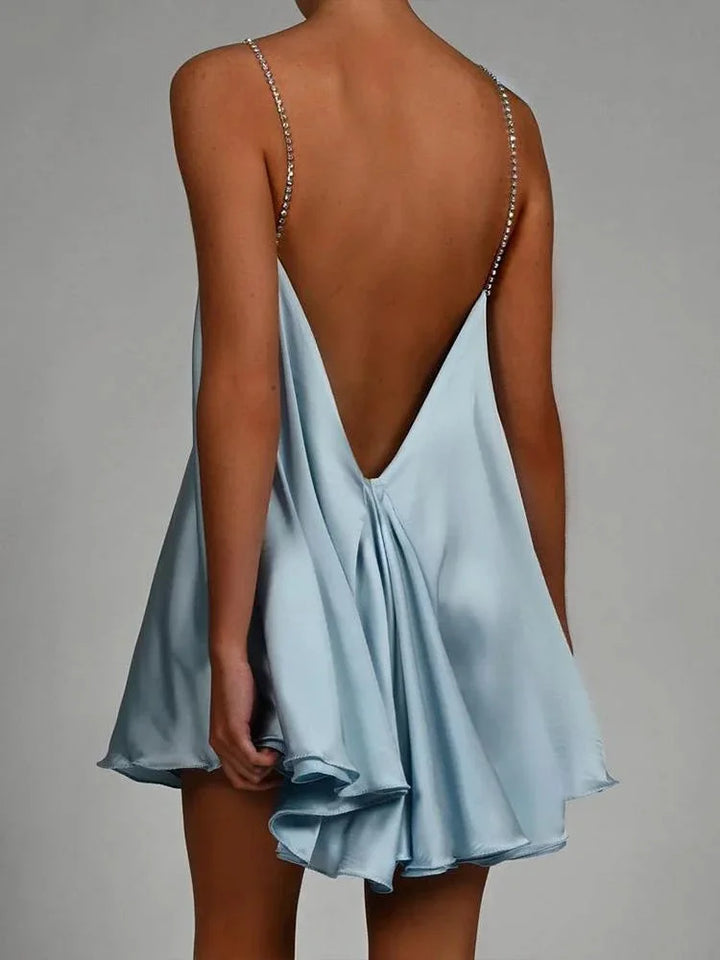 "Sleek satin dress with chain embellishments, elegant and flowing design by Justyce"