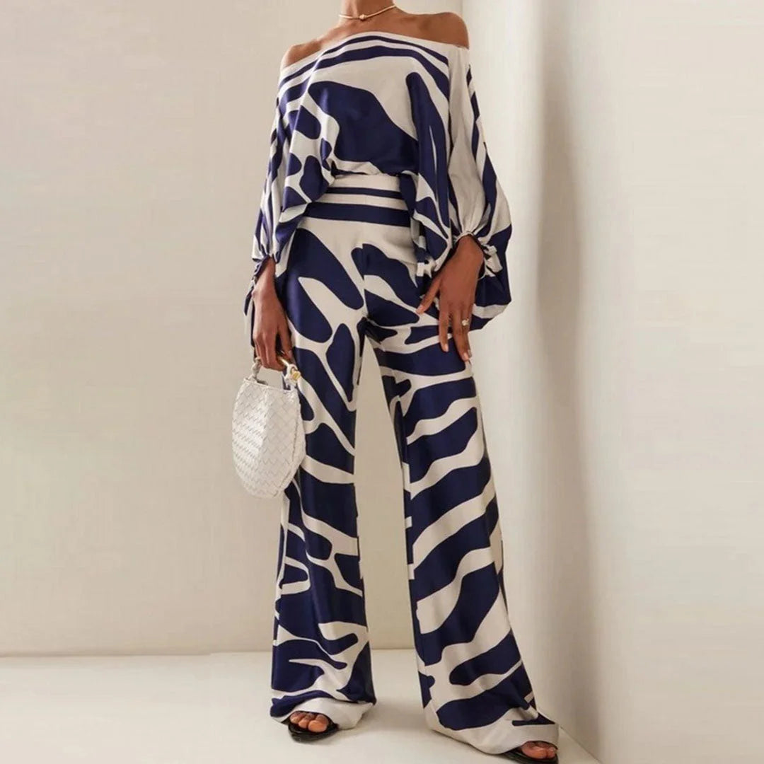 Blue off-shoulder blouse and straight pants set featuring a soft, lightweight fabric with a flattering design.
